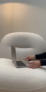 A person working on a laptop in a bright workspace for freelance digital marketing.